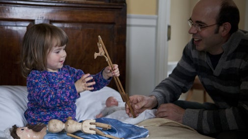 A child plays with traditional Georgian toys in the children's bedroom at Wordsworth House, Cockermouth